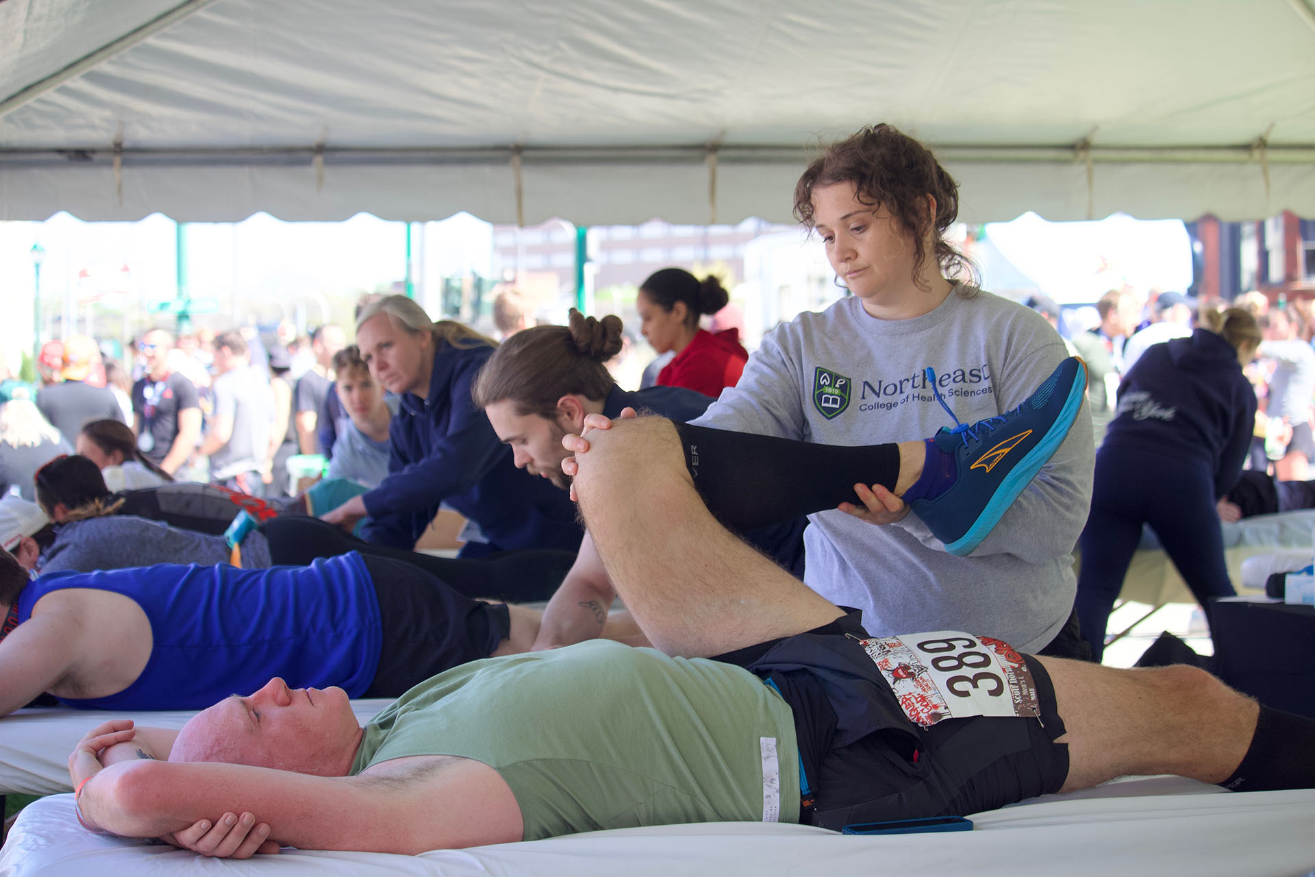 Northeast chiropractic workers in tent at fitness event