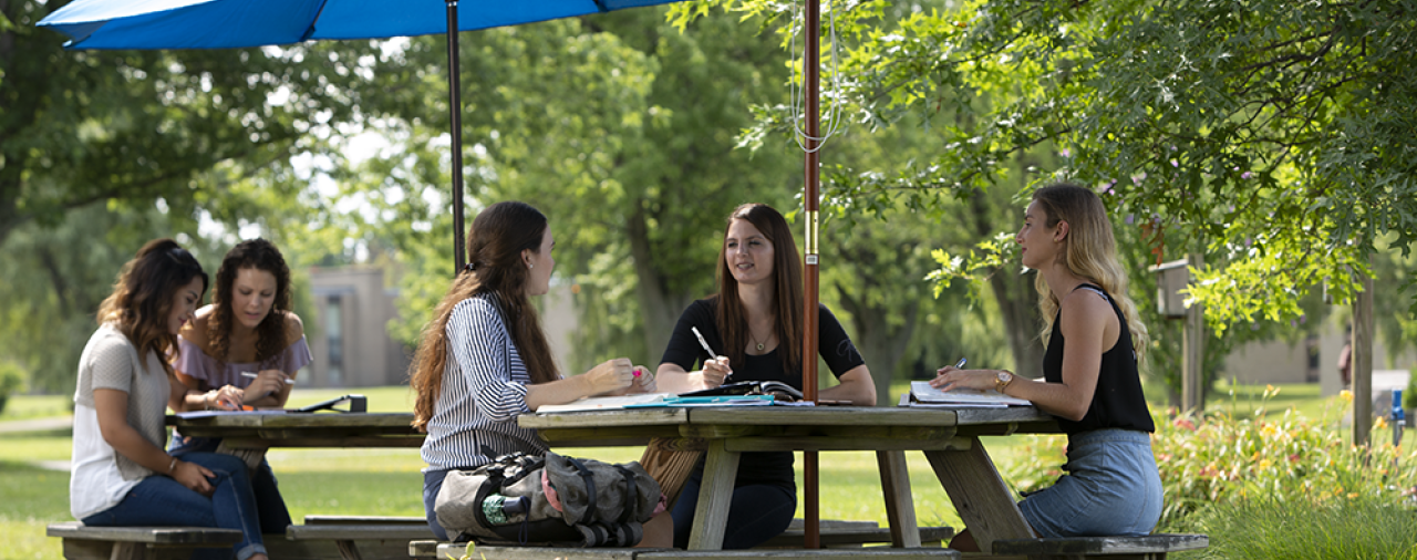 students sitting outside at a table